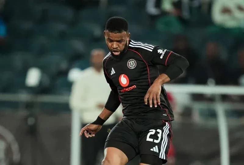 Player in black jersey dribbling ball on field