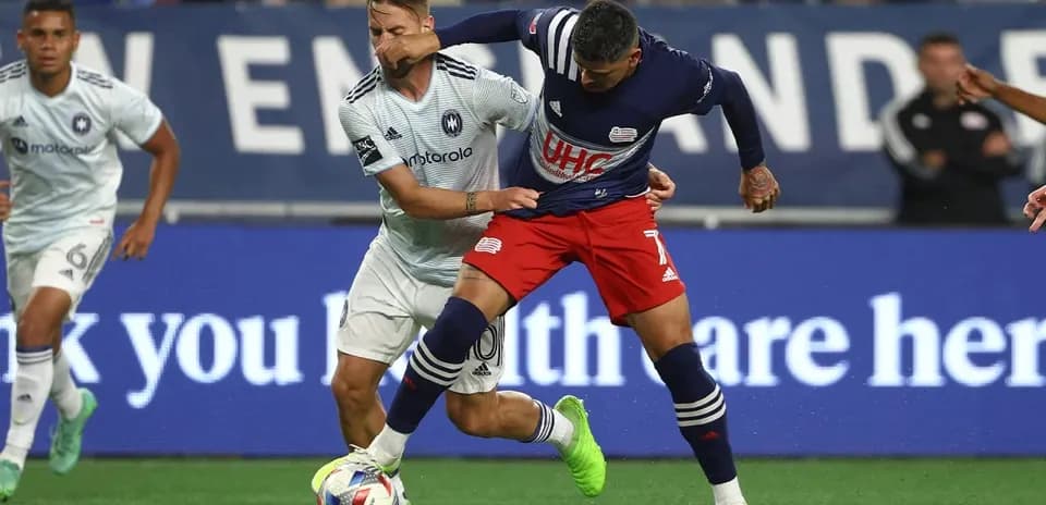 Players competing for the ball in MLS Next Pro match