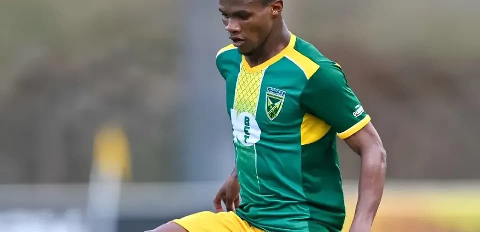 Player in green and yellow uniform during training
