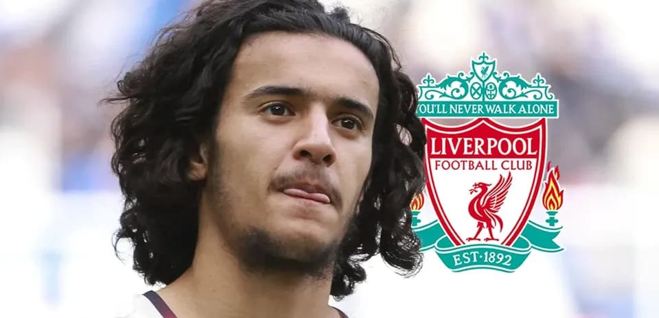 Player with long hair next to Liverpool FC logo