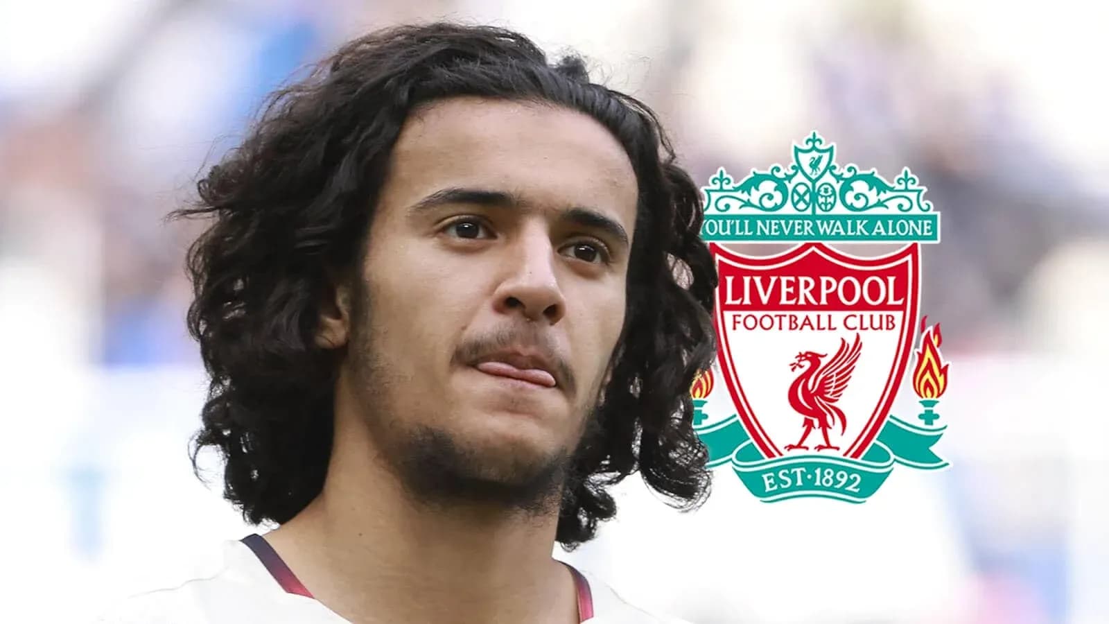 Player with long hair next to Liverpool FC logo