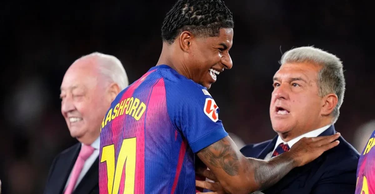 Marcus Rashford smiling with club officials at event
