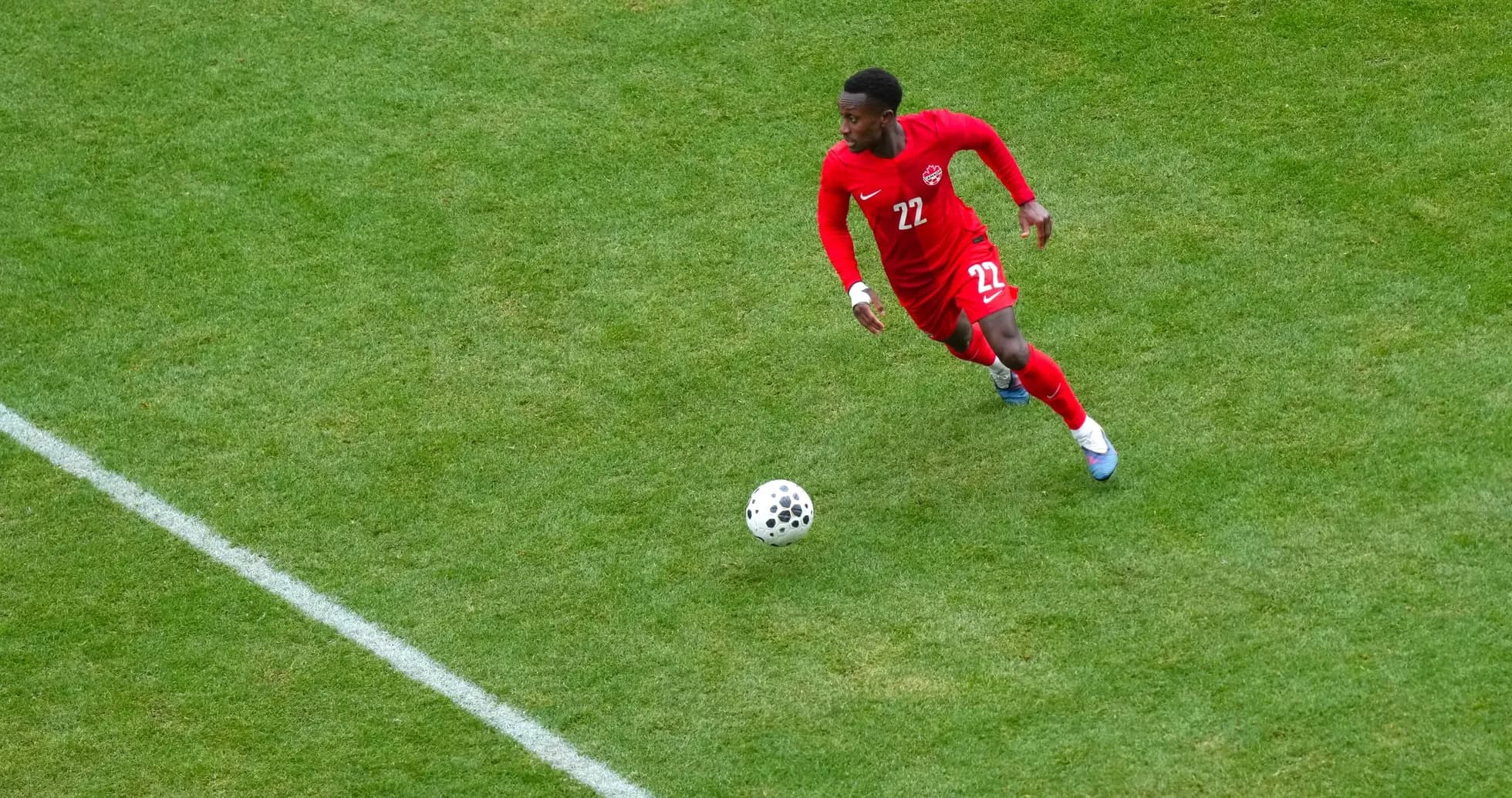 Player in red jersey dribbling the ball