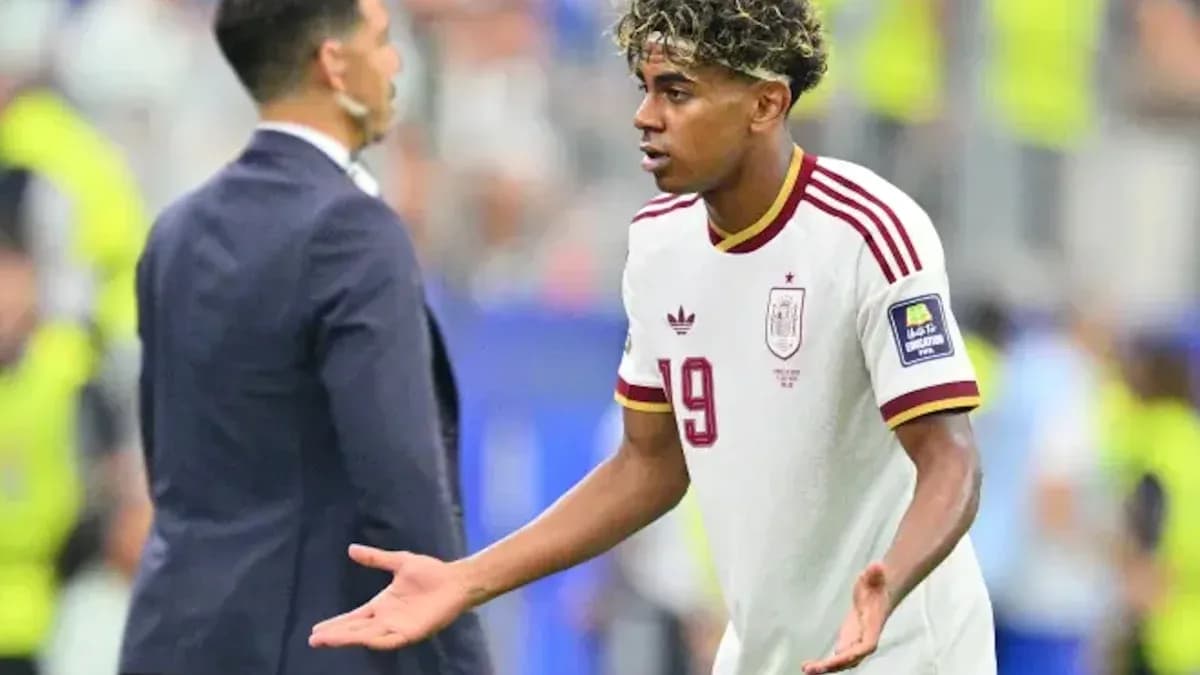 Player gesturing during match with coach nearby