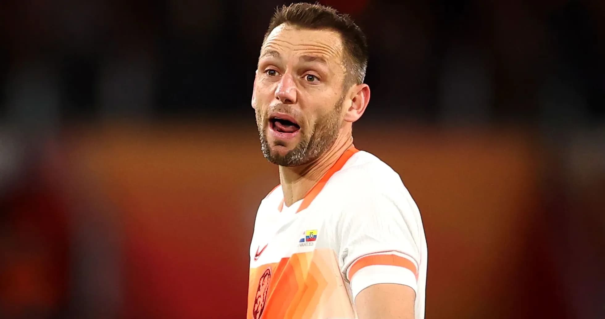 Player in Dutch kit reacting during a match