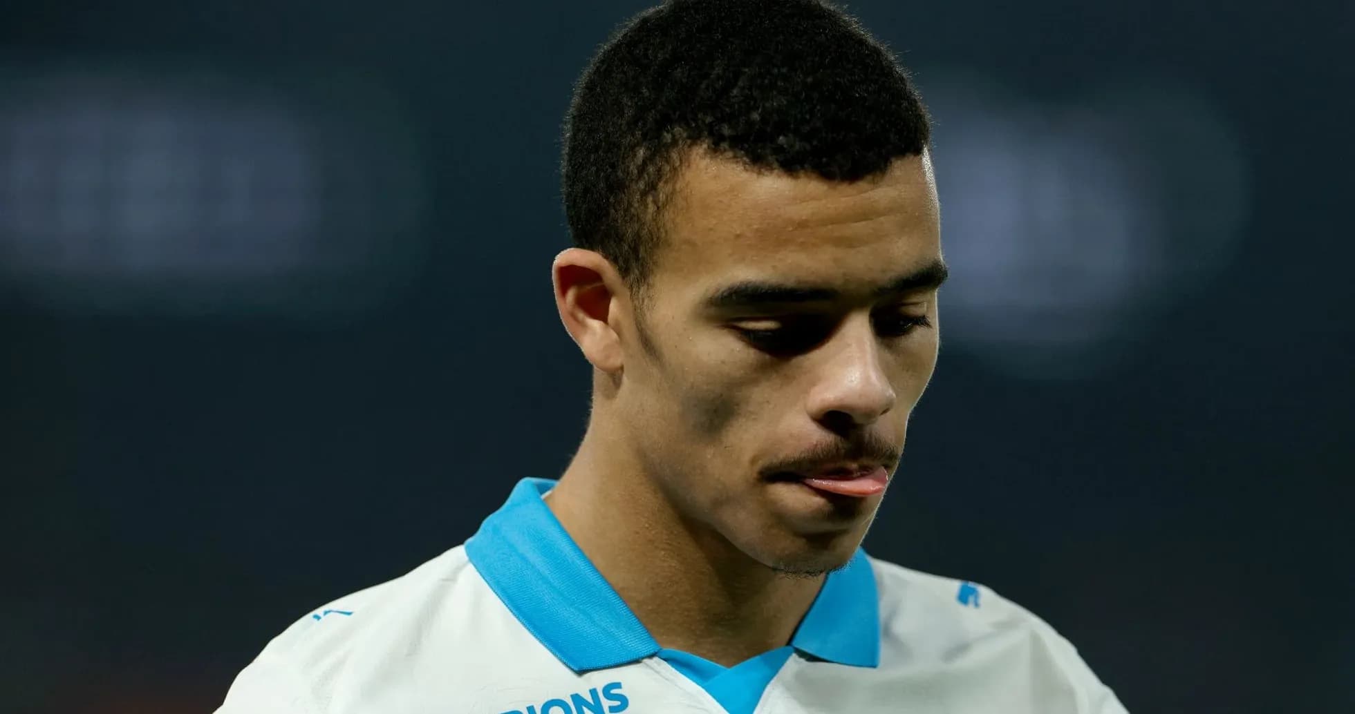 Player looking down in team jersey during match