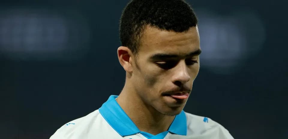 Player looking down in team jersey during match