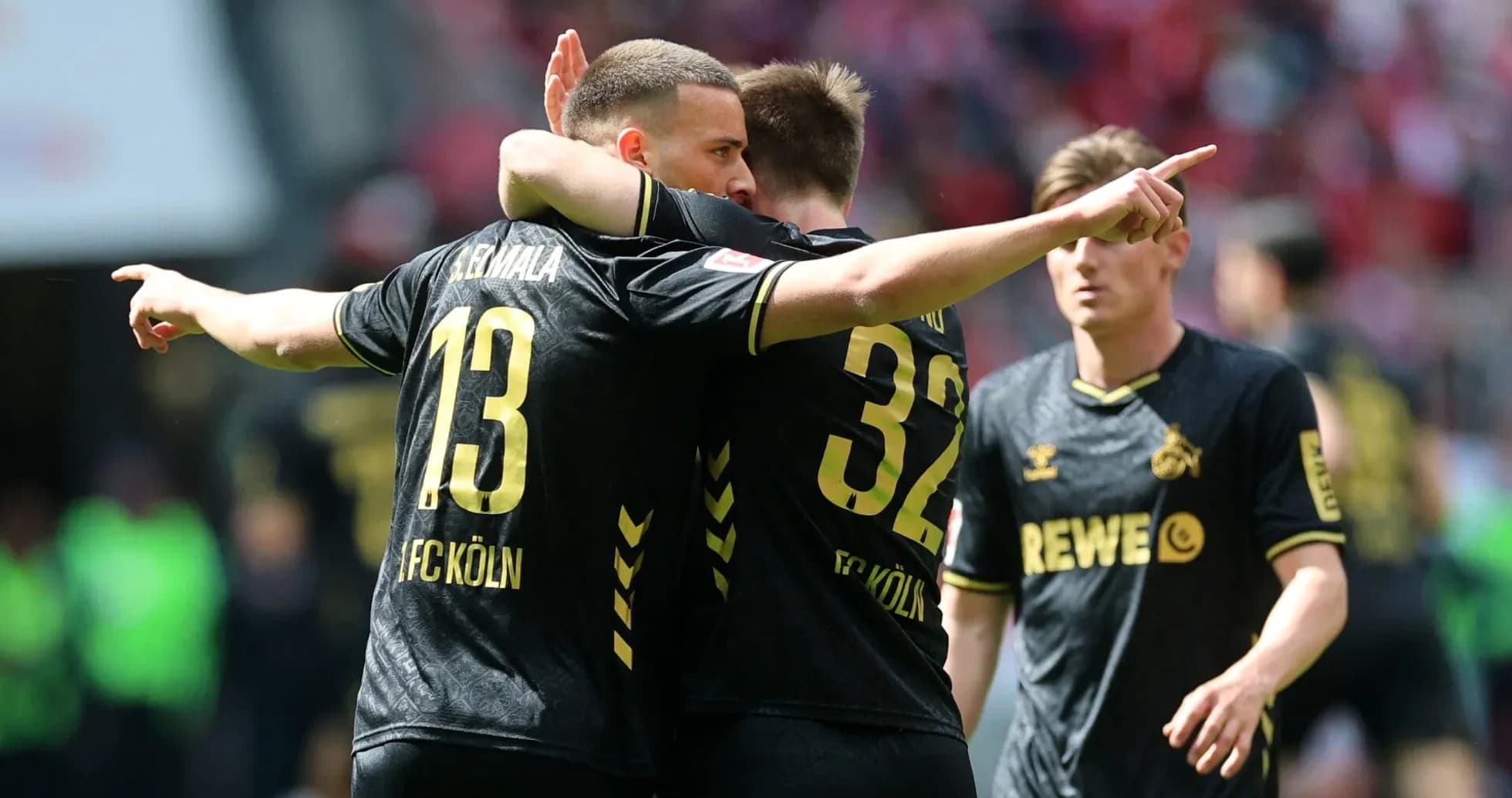 FC Köln players celebrating a goal together