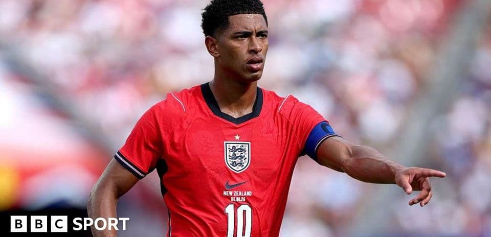 Player wearing red England jersey pointing on field