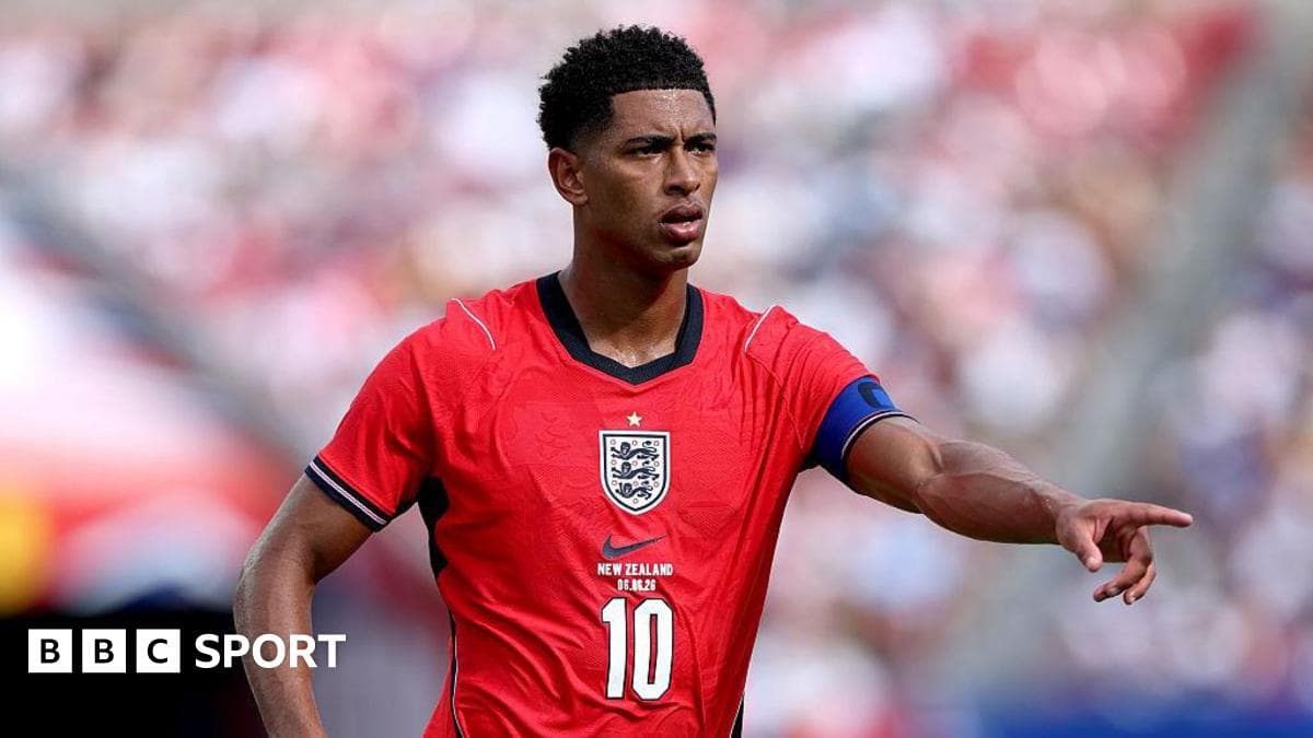 Player wearing red England jersey pointing on field