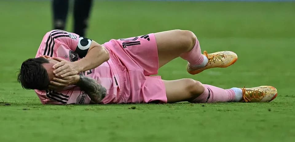 Player lying on the ground holding face
