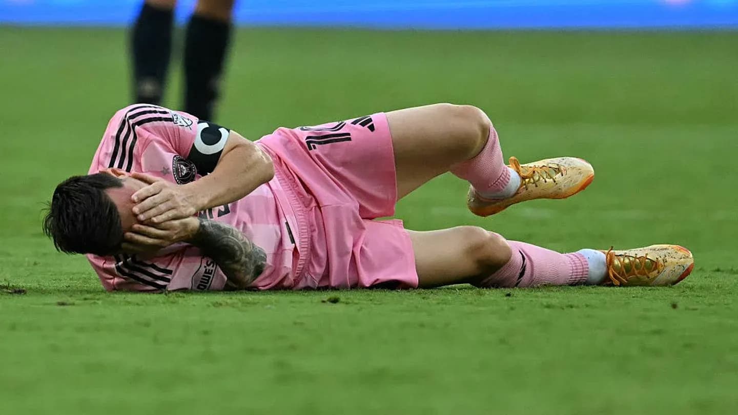 Player lying on the ground holding face