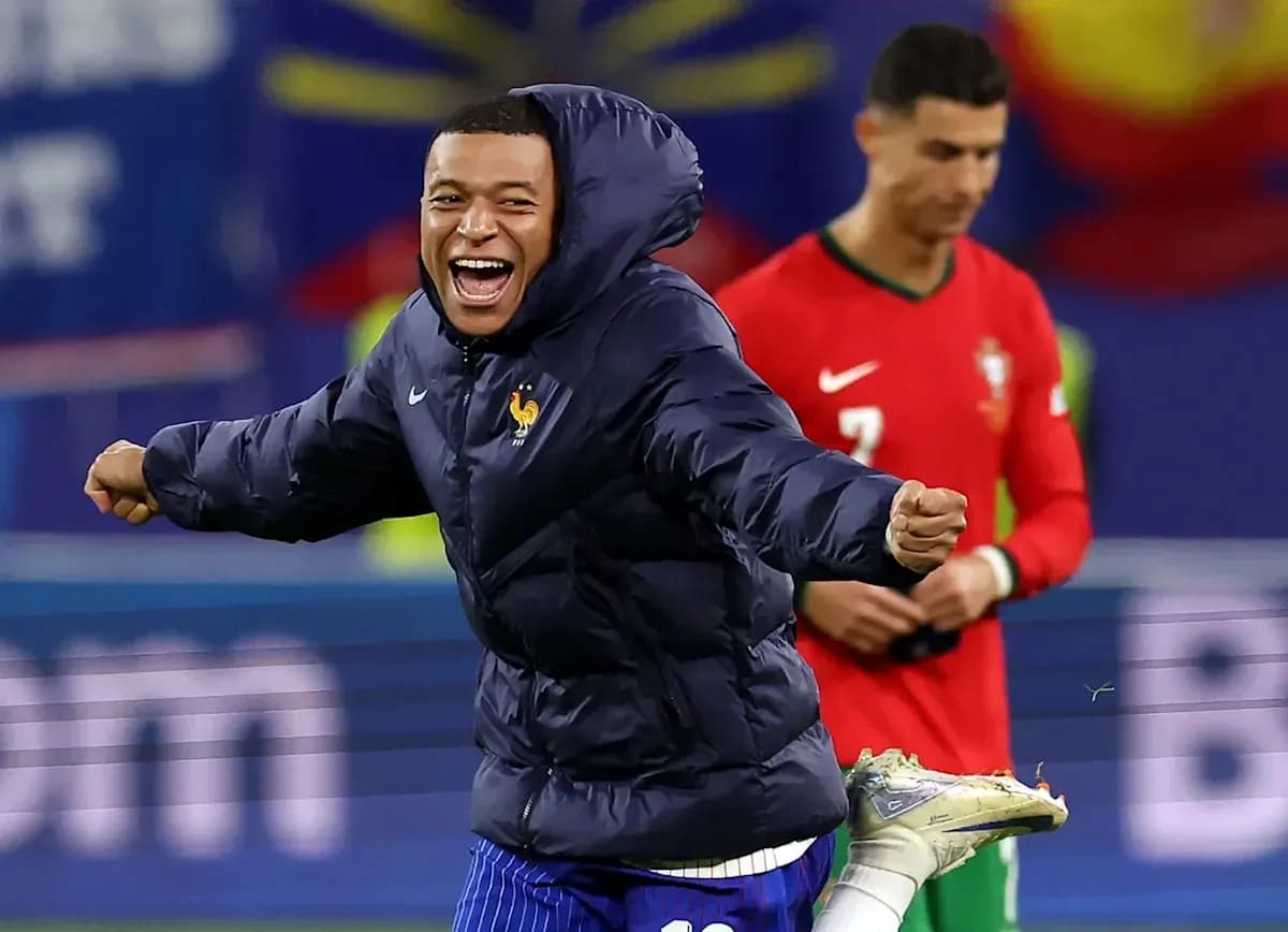 Player in blue jacket celebrating on the pitch