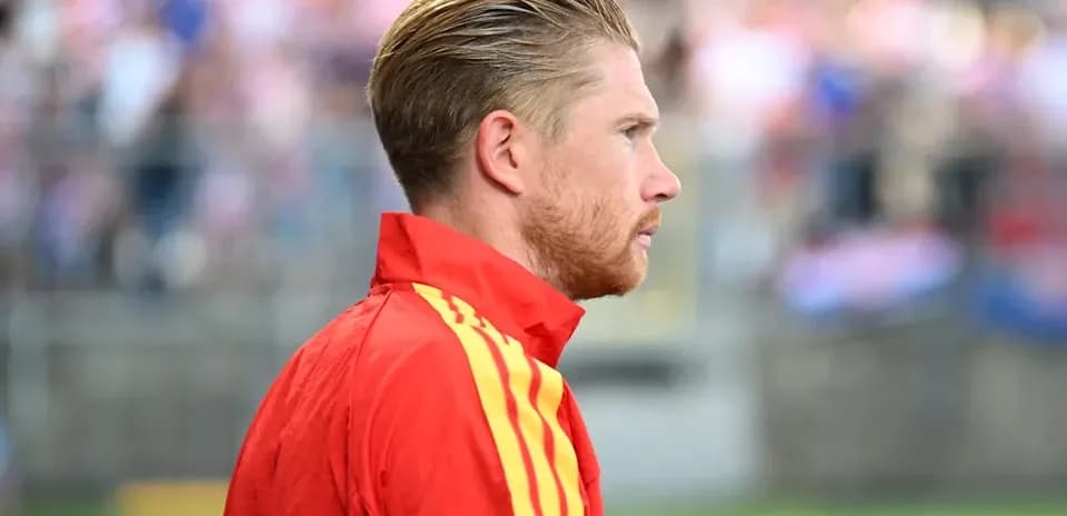 Player in red training kit on the sidelines