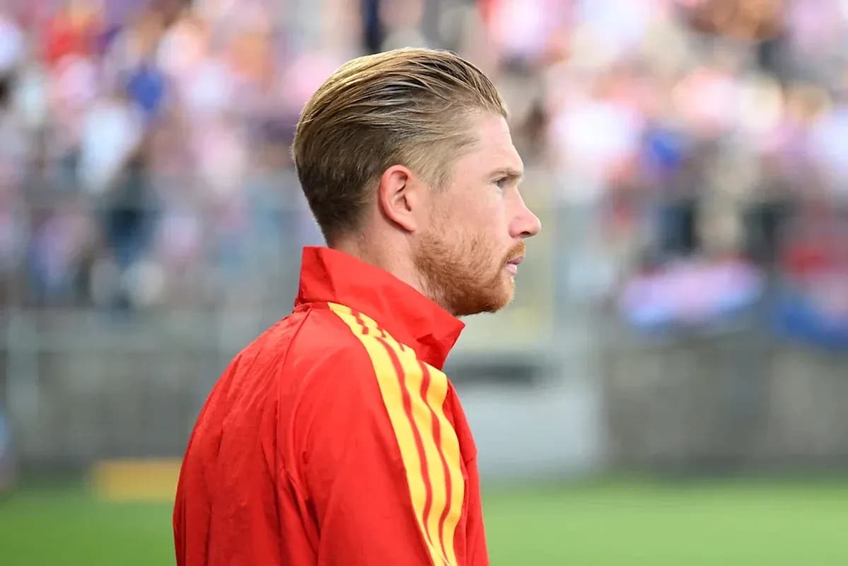 Player in red training kit on the sidelines
