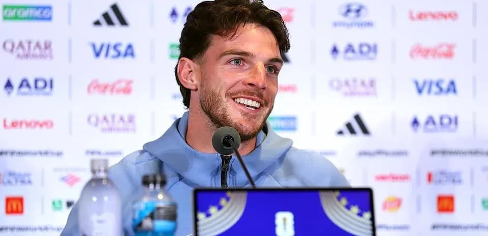 Player speaking at press conference with microphones