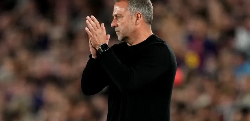 Coach clapping during a match on the sidelines