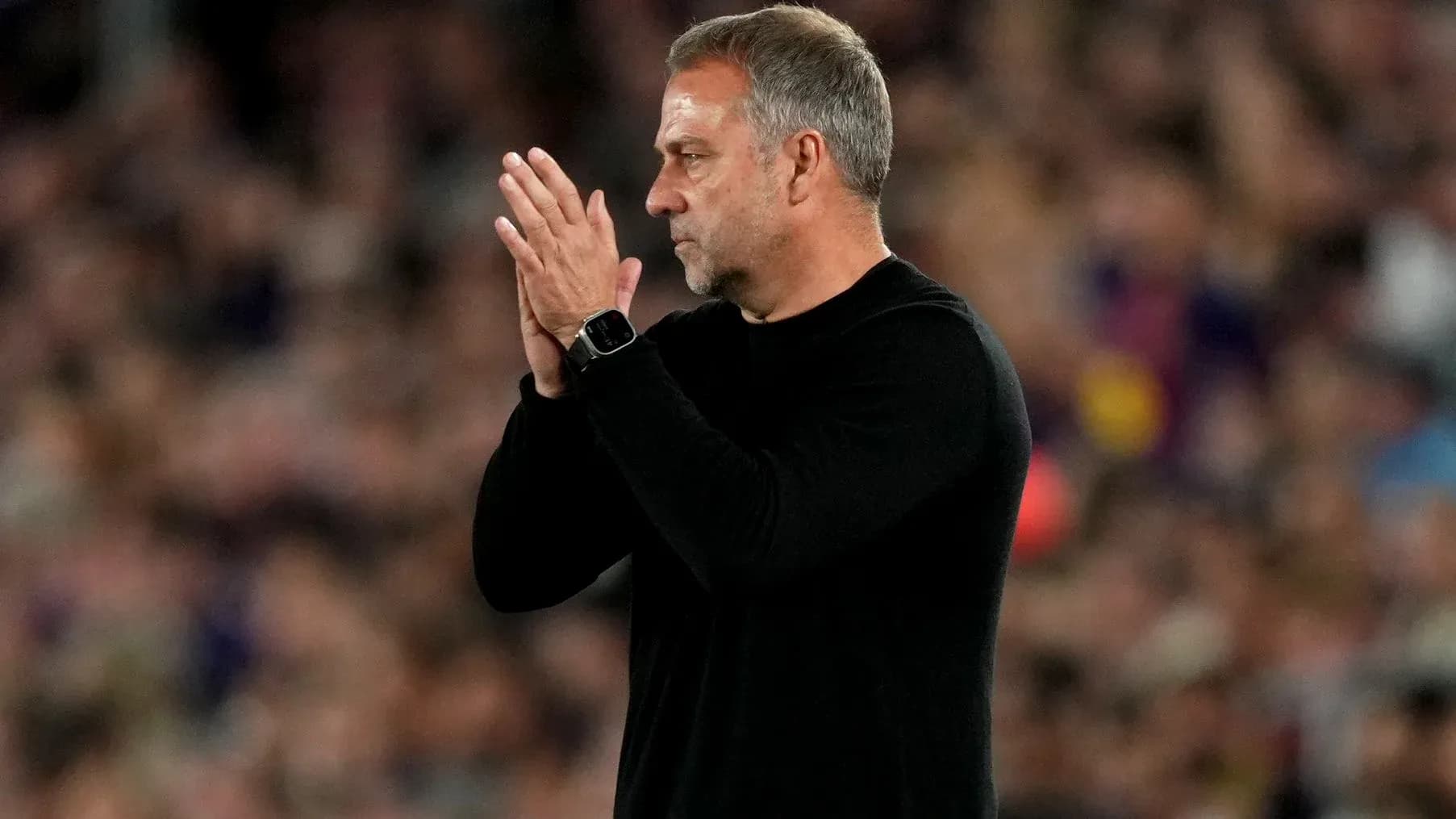 Coach clapping during a match on the sidelines