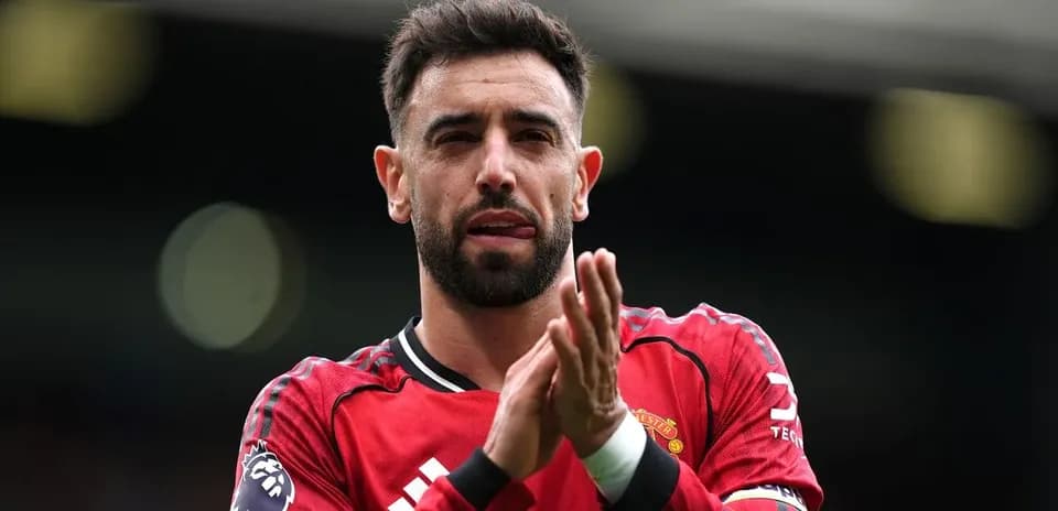 Player applauding fans wearing Manchester United jersey