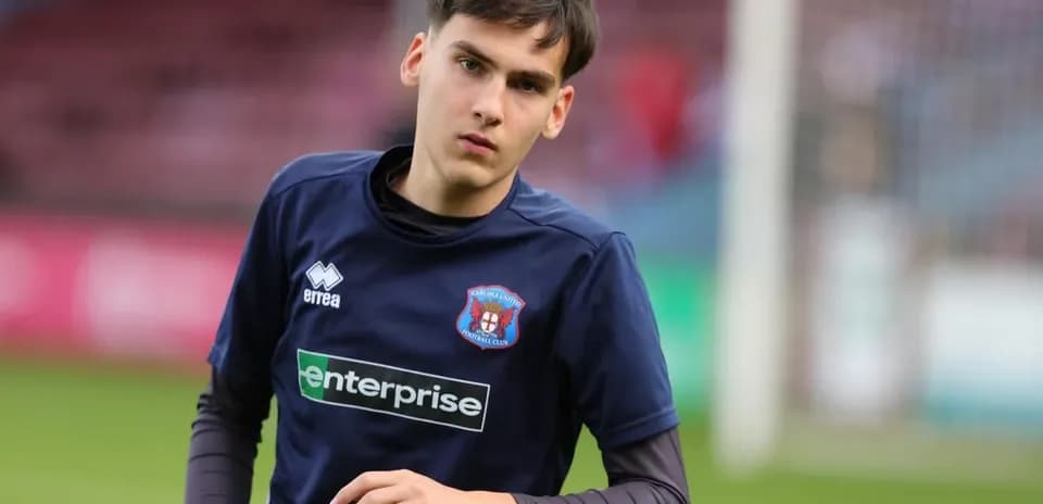 Player warming up in Carlisle United training kit