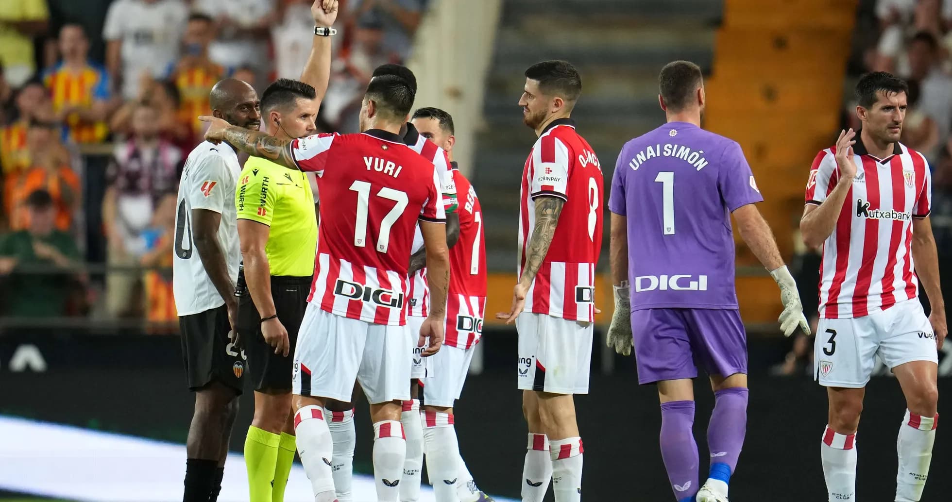 Players reacting to red card during match