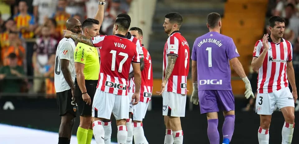 Players reacting to red card during match