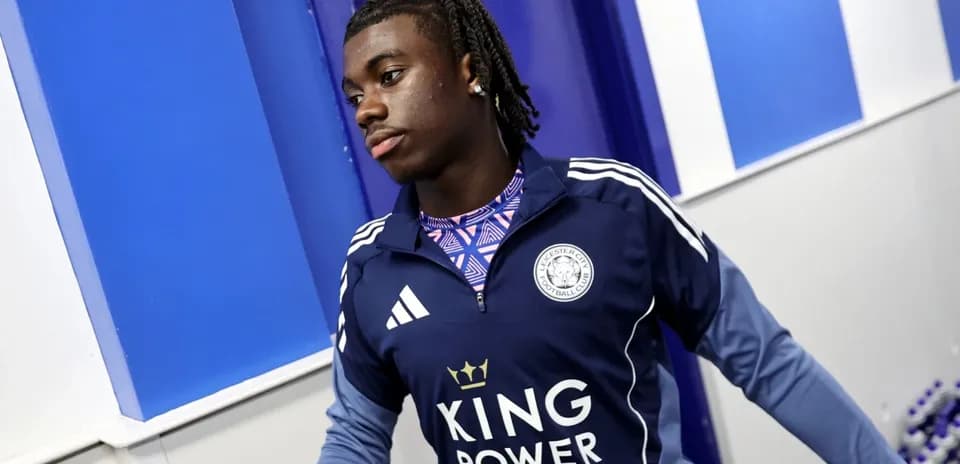 Player in Leicester City training kit walking indoors