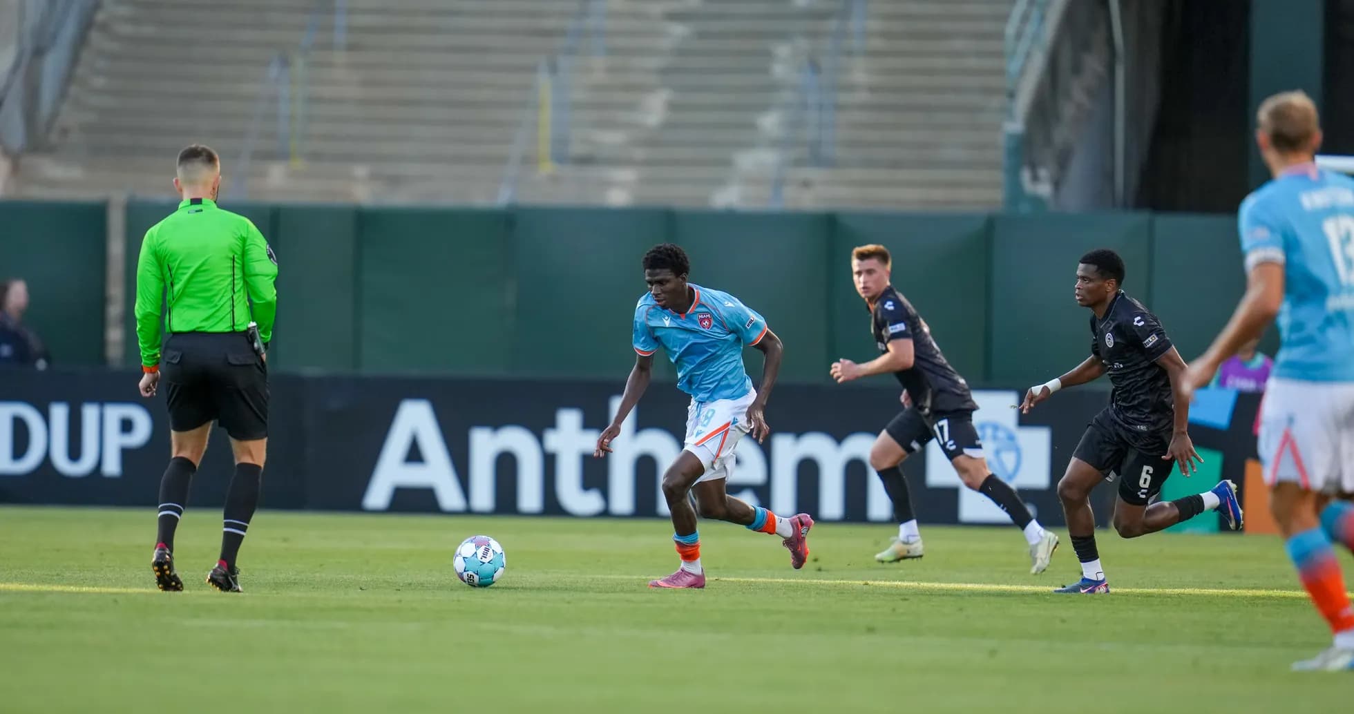 Player dribbling ball during Oakland Roots match