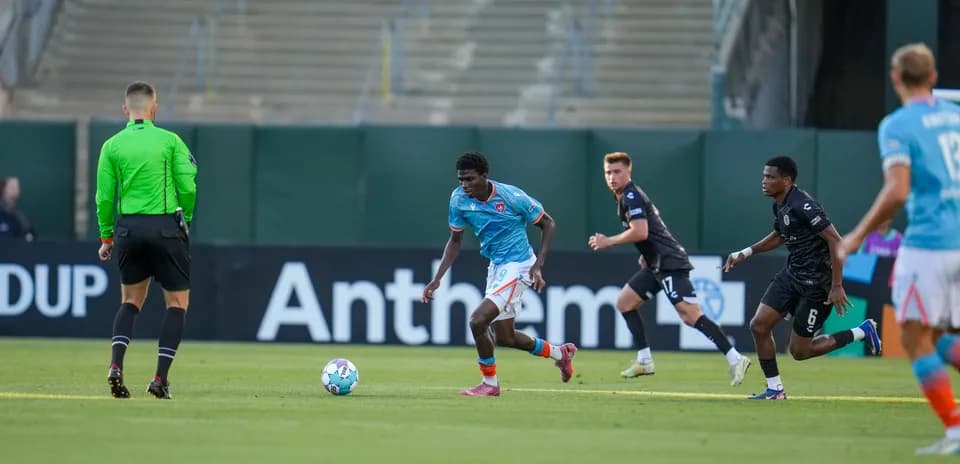Player dribbling ball during Oakland Roots match