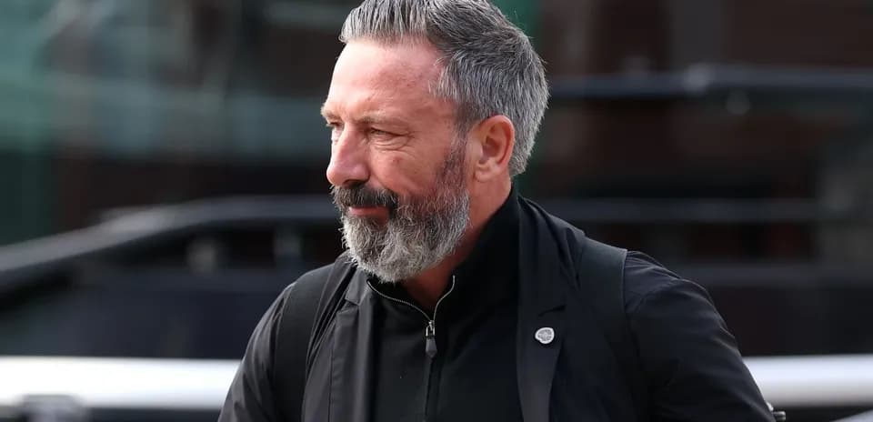 Man with gray beard walking outdoors