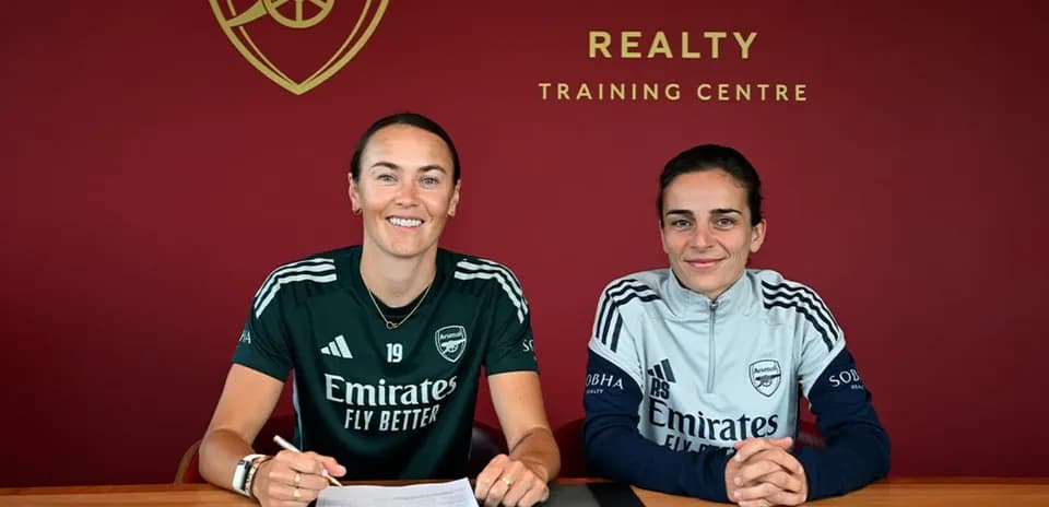 Two players signing contracts at Arsenal training center