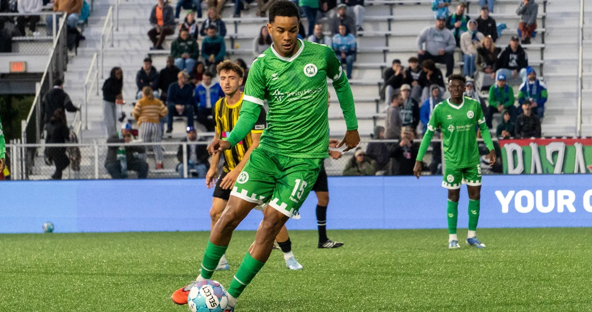 Player in green uniform preparing to kick ball
