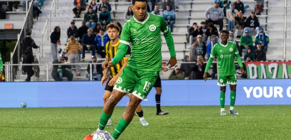 Player in green uniform preparing to kick ball
