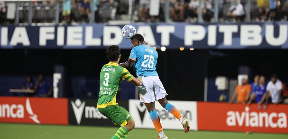 Player heading the ball during match action