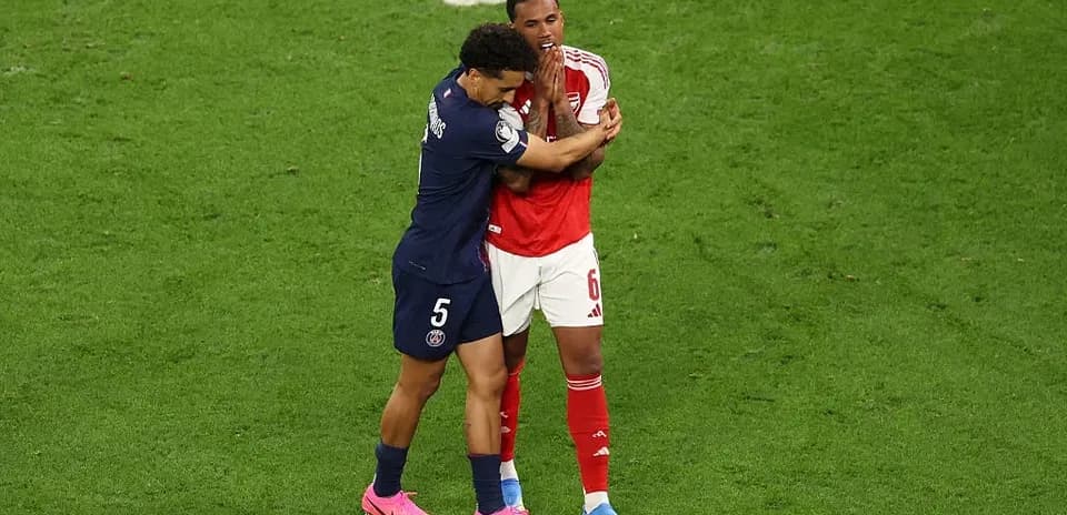 Two players embracing on the soccer field