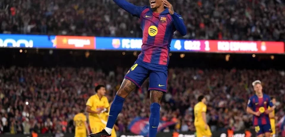 Barcelona player celebrating goal in stadium crowd