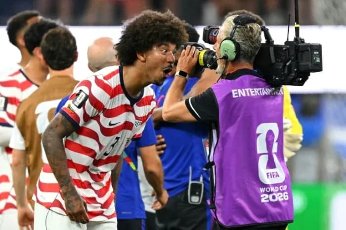 US player celebrating with camera after match