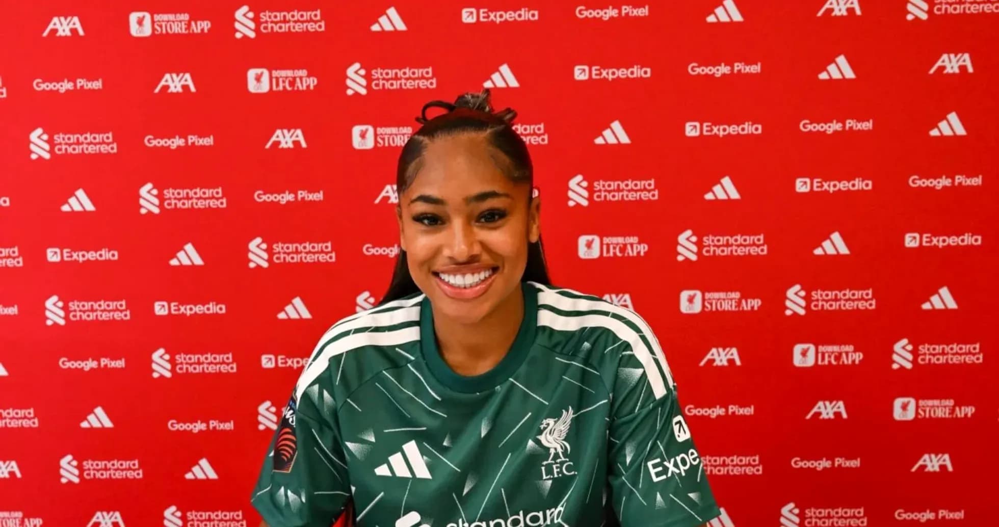 Player smiling at press conference in Liverpool jersey