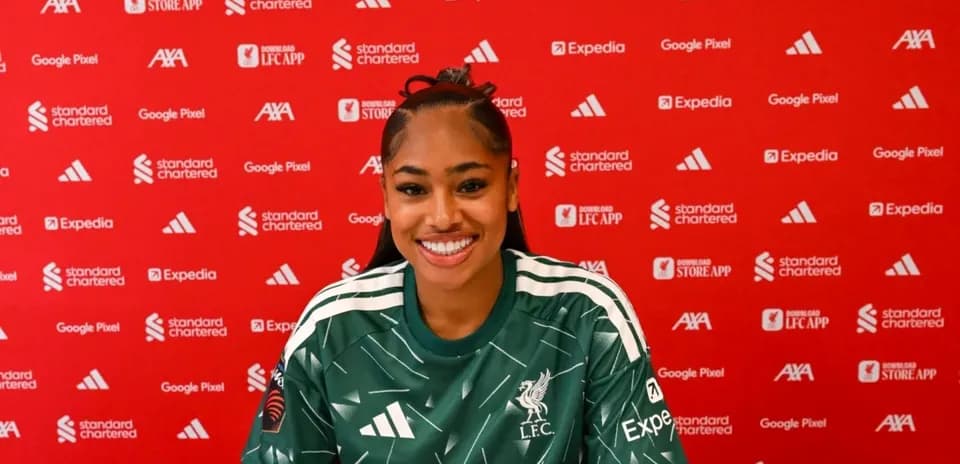 Player smiling at press conference in Liverpool jersey