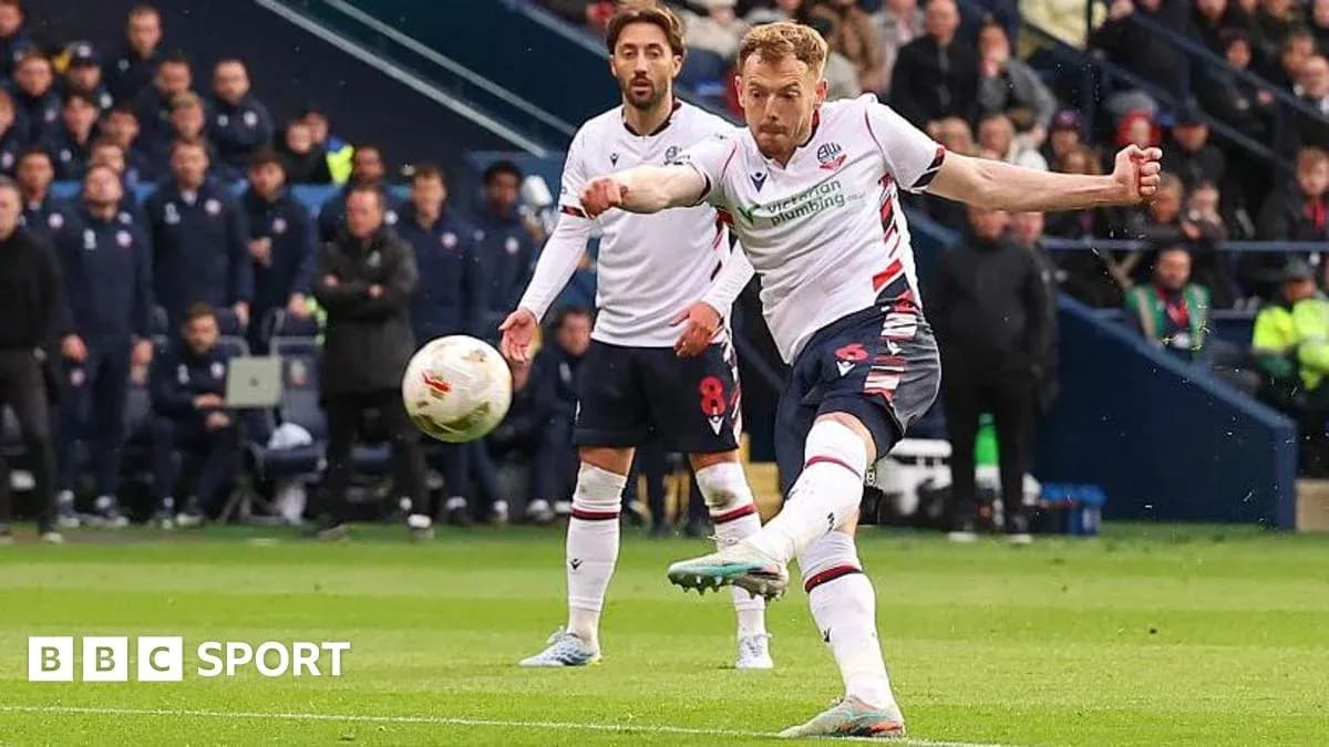 Player striking the ball during a football match