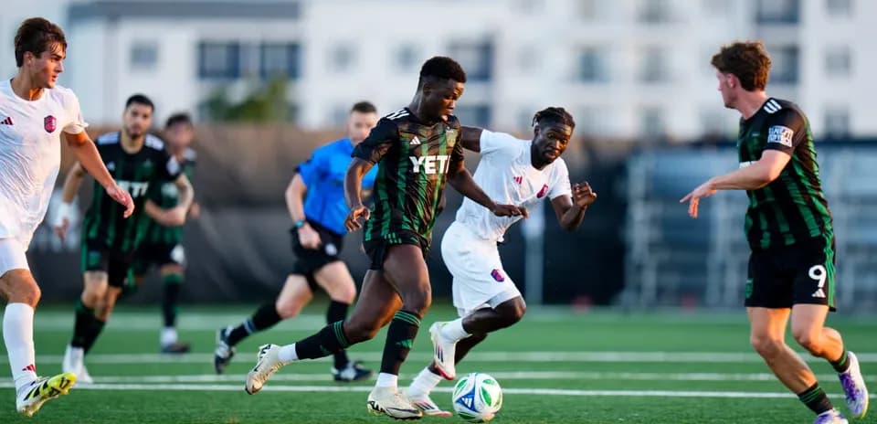 Players competing for the ball in MLS Next Pro