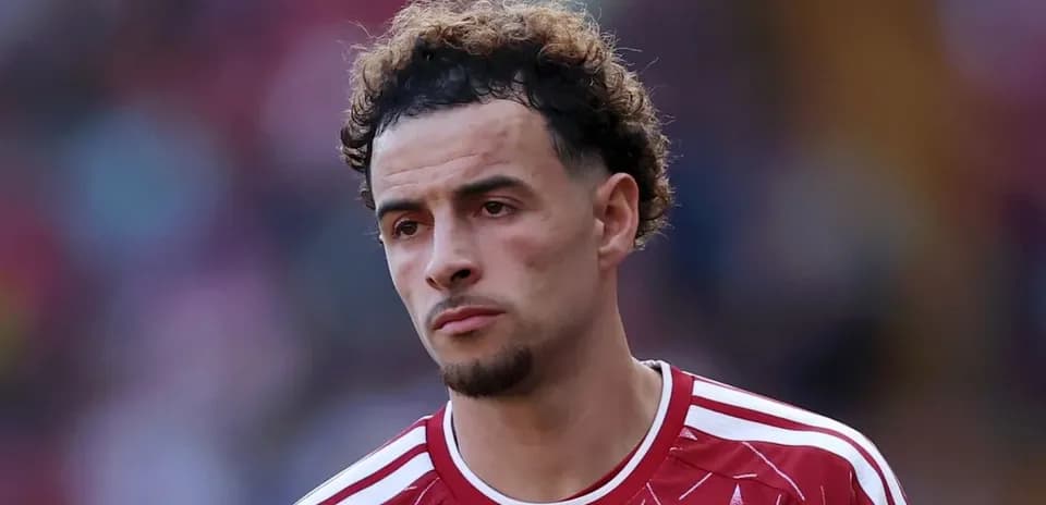 Player in red jersey looking focused during match
