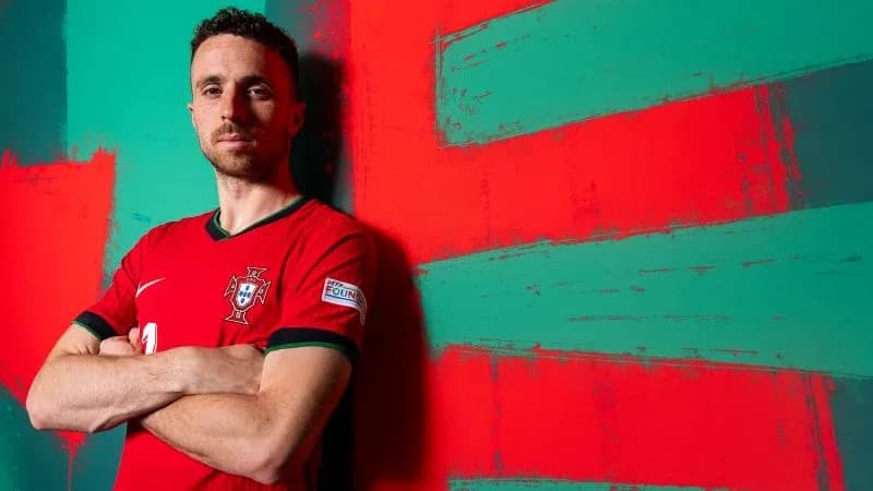 Football player posing in Portugal national team jersey