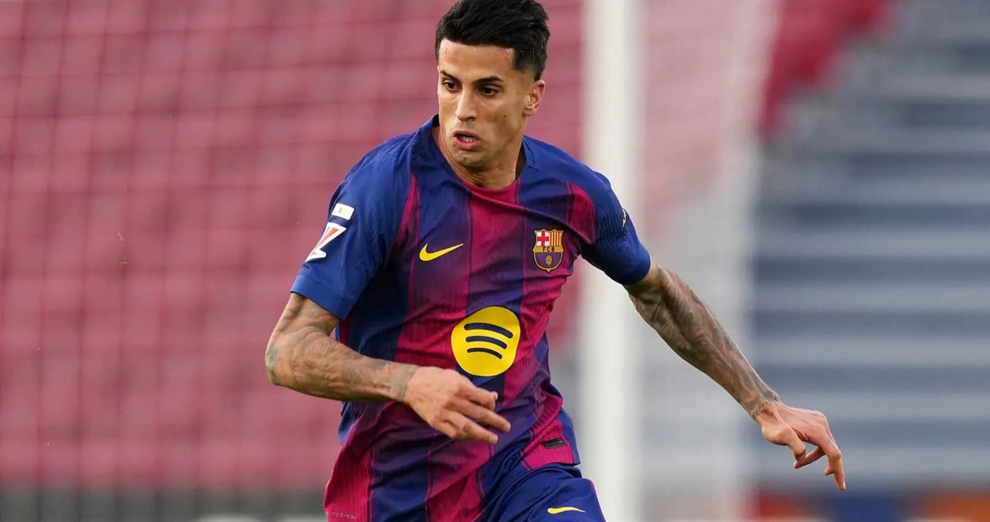 Player in FC Barcelona kit running on the pitch