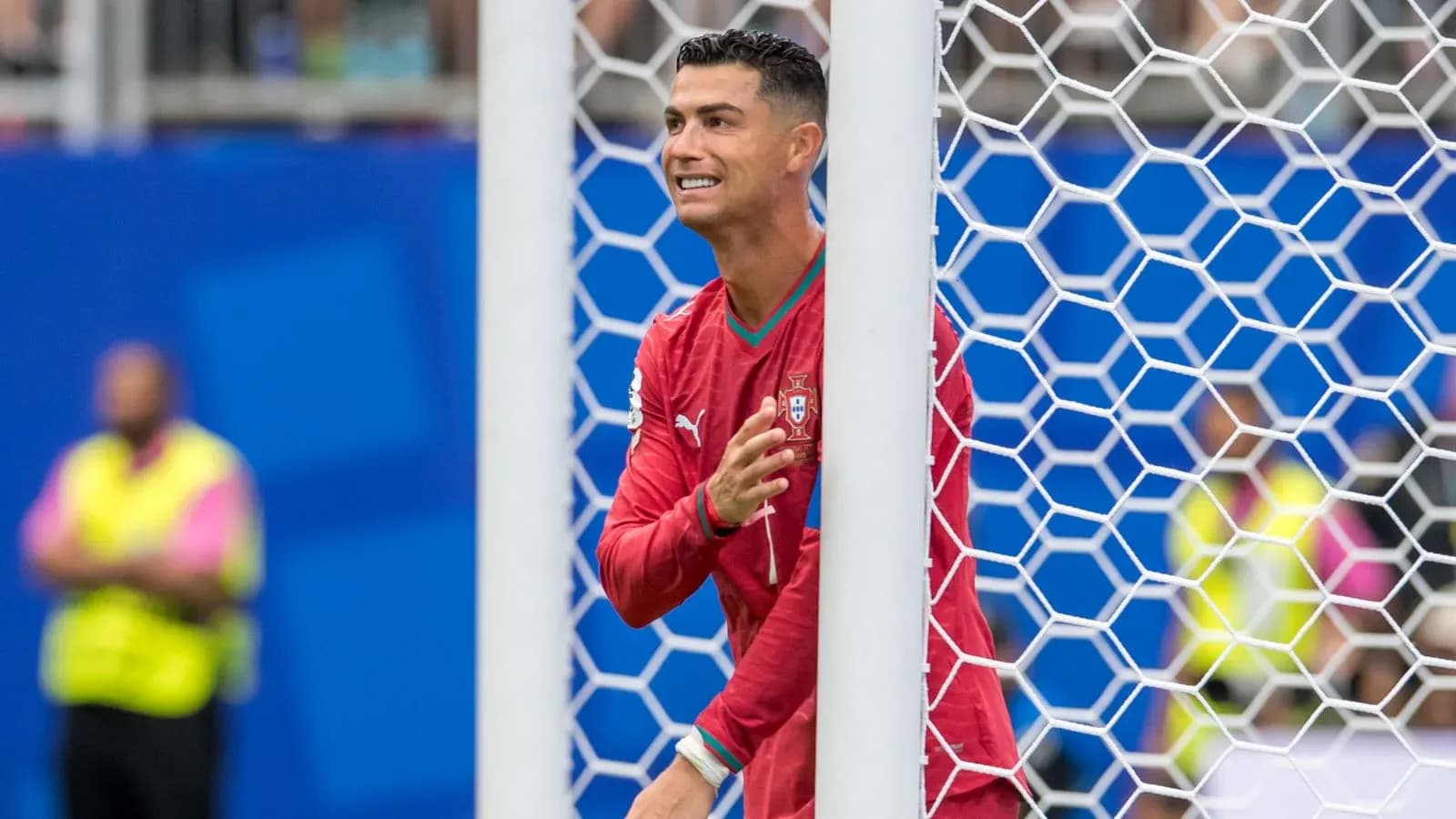 Cristiano Ronaldo celebrating behind goal net