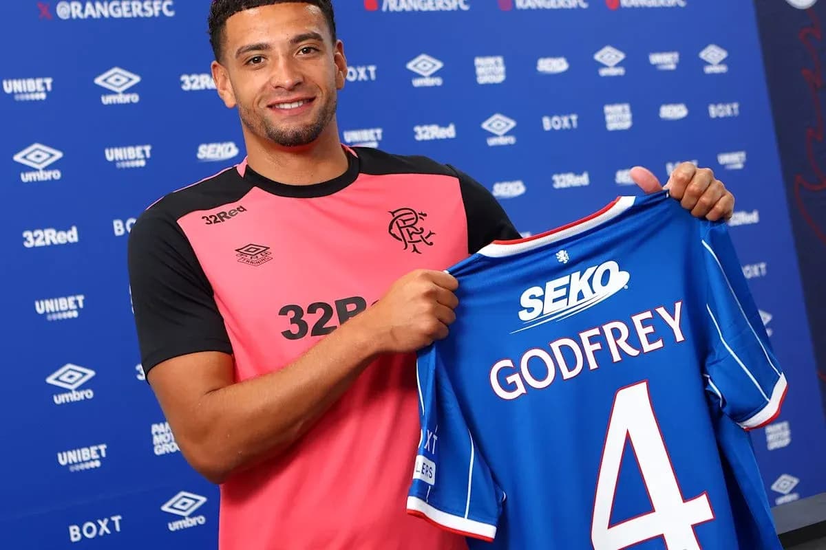 Player holding new jersey at signing event