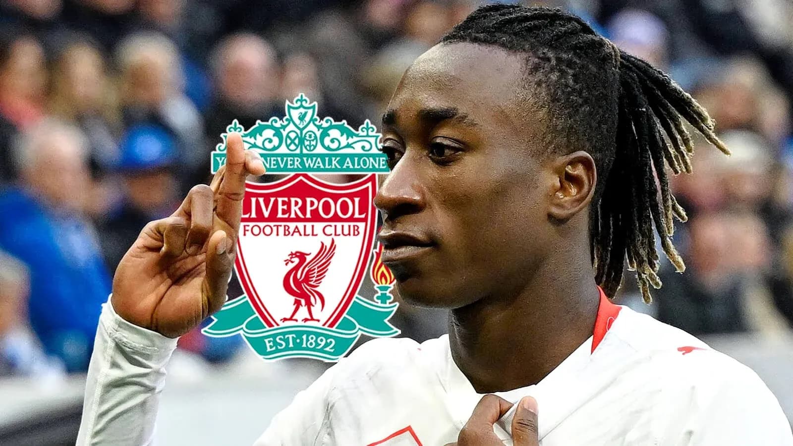 Player celebrating with Liverpool logo in background
