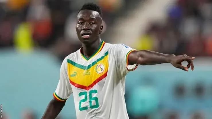 Player in Senegal jersey directing teammates on field