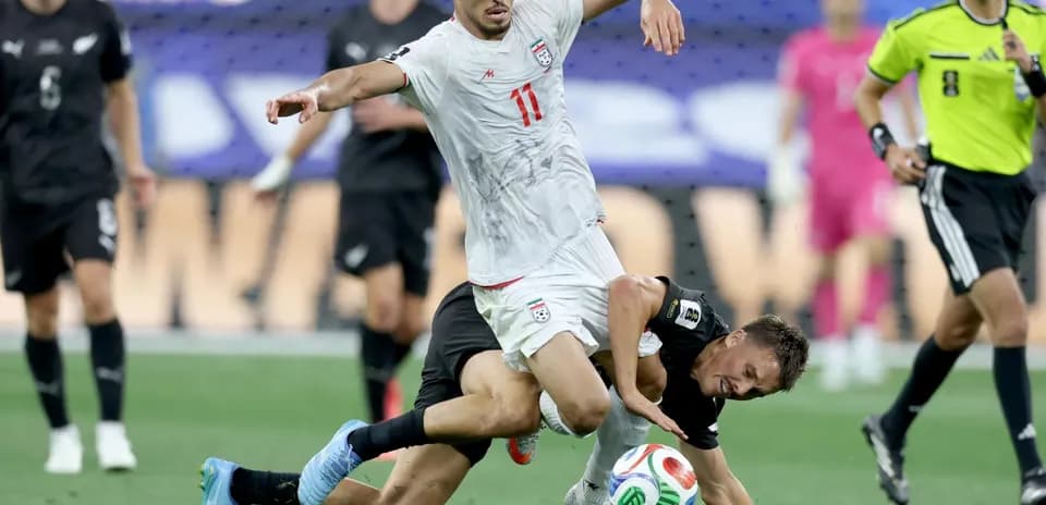 Iran player challenges New Zealand player during match