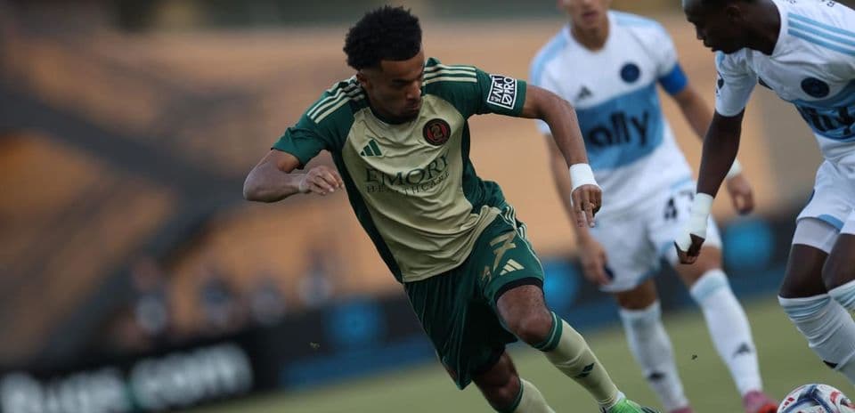 Atlanta United II player dribbling against Crown Legacy